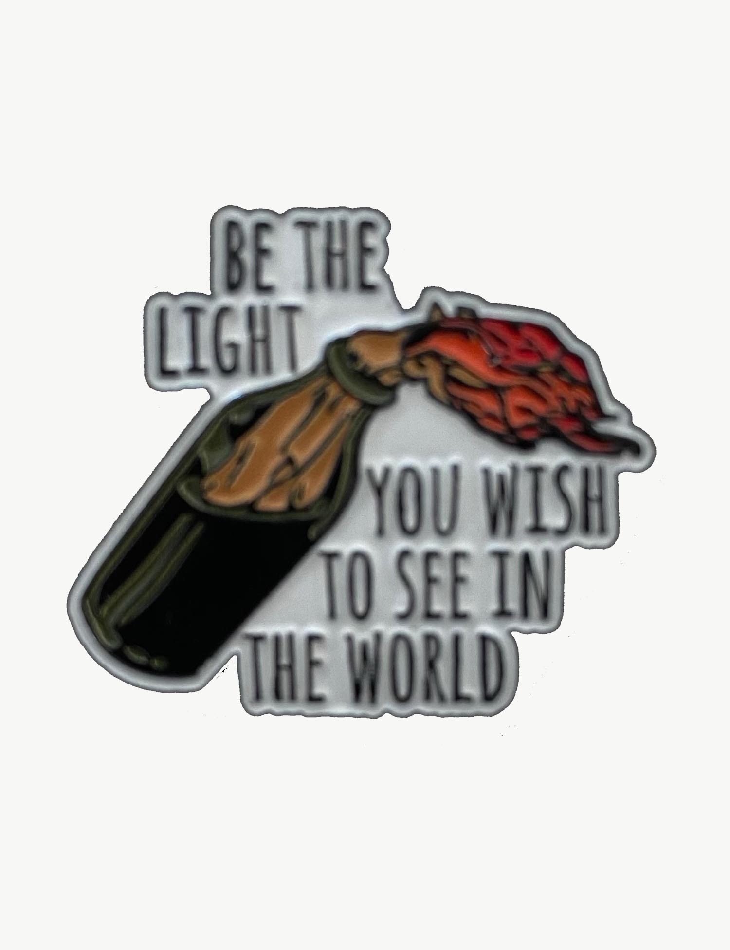 Pin's militant "Be the light you wish to see in the world"